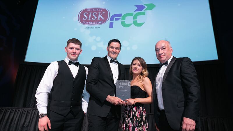 Andrew Howley, Awards Judge, presents Education Project of the Year award to SISK FCC team