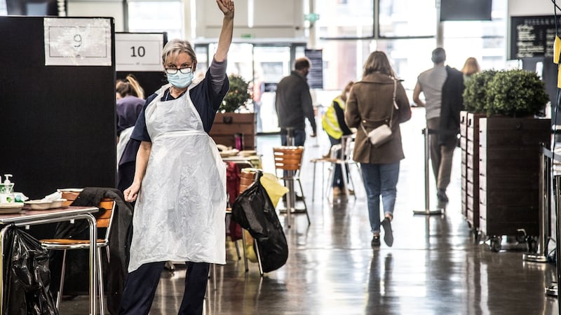 A healthcare worker at the vaccination centre at Newbury Racecourse, Newbury, England. Photograph: www.thisisjude.uk, Glenn Edward, Liam McBurney and the NHS/PA Wire