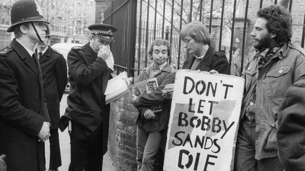 Policemen talk to men bearing banners on behalf of hunger striker Bobby Sands, during a May Day march at Clerkenwell Green in London in May 1981. Photograph: Central Press/Getty Images