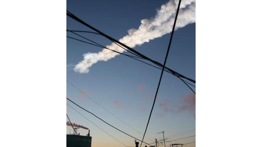 The trail of a falling object is seen above Chelyabinsk. A shock wave from the blast destroyed a wall in a concentrate warehouse at the Chelyabinsk Zinc Plant site and smashed windows in other buildings. Photograph: www.chelyabinsk.ru/Reuters