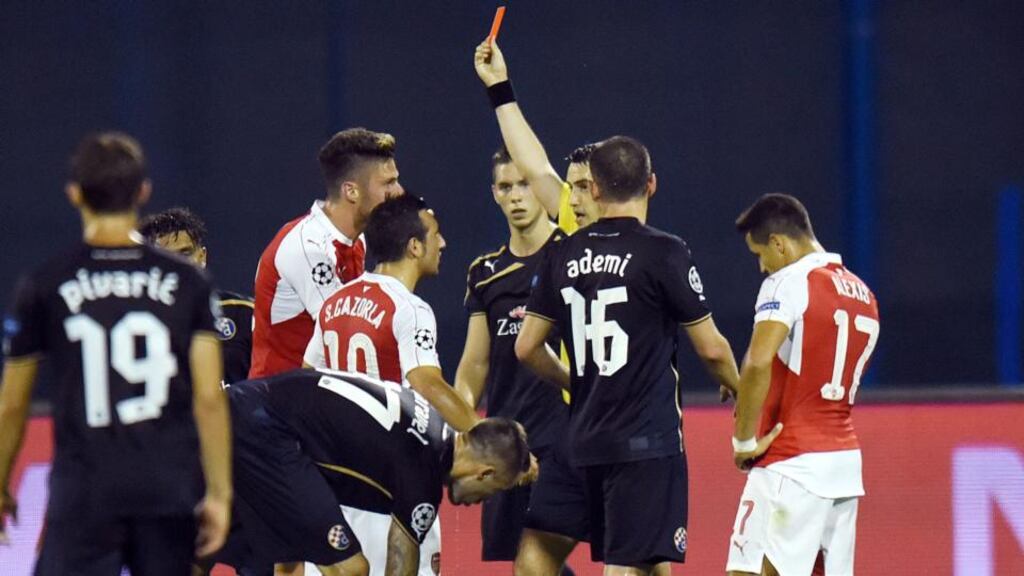 The referee shows a red card to Arsenal’s Oliver Giroud during their Champions League Group F match against GNK Dinamo Zagreb. Photograph: Getty Images