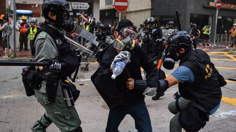 Police detain a protester on a road in the Wanchai area of Hong Kong. Photograph: Nicolas Asfouri/AFP/Getty Images