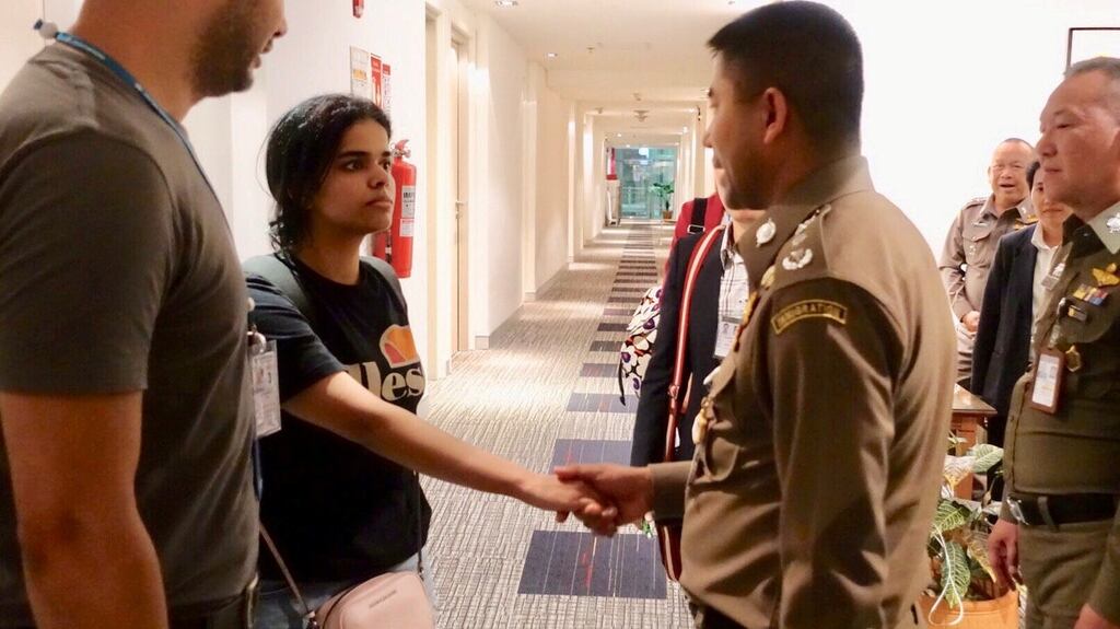 Saudi teen Rahaf Mohammed al-Qunun is greeted by Thai immigration authorities at a hotel inside Suvarnabhumi Airport in Bangkok, Thailand. Photograph: Reuters
