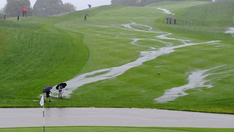 The flooded 18th fairway is pictured after heavy rainfall during the opening fourball matches. Photo: Glyn Kirk/AFP via Getty Images