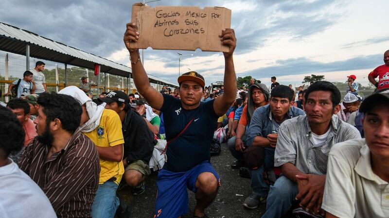 A Honduran migrant taking part in the caravan holds up a sign reading “Thank you Mexico for opening your hearts to us”, while he waits to cross the border from Ciudad Tecun Uman in Guatemala, to Ciudad Hidalgo, Mexico earlier this week. Photograph: Orlando Sierra/AFP/Getty Images