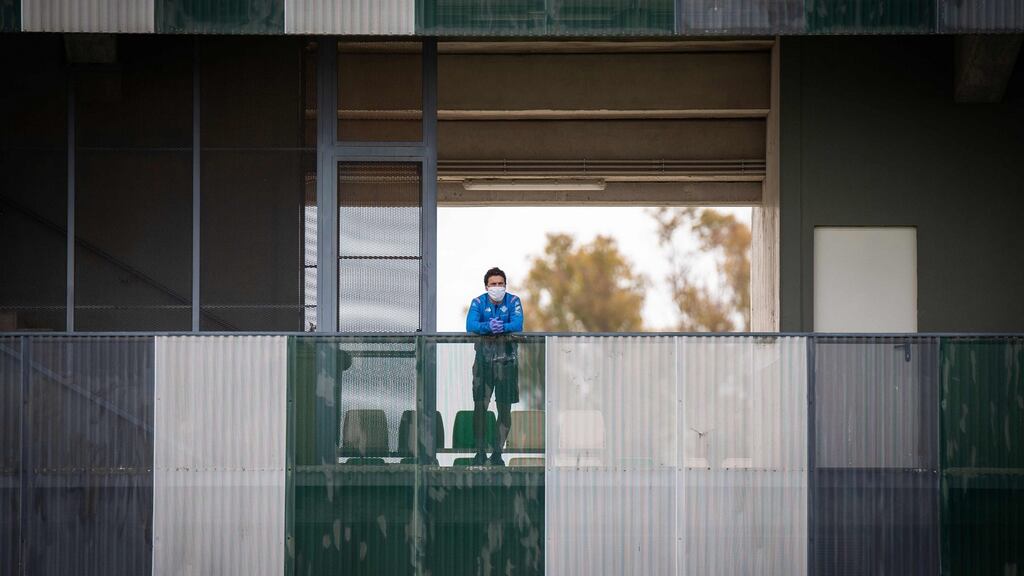 Real Betis coach Rubi wearing a face mask while observing players from a balcony during a training session at the Luis del Sol training ground in Seville. Photograph:  Fernando Ruso/Real Betis/AFP via Getty Images