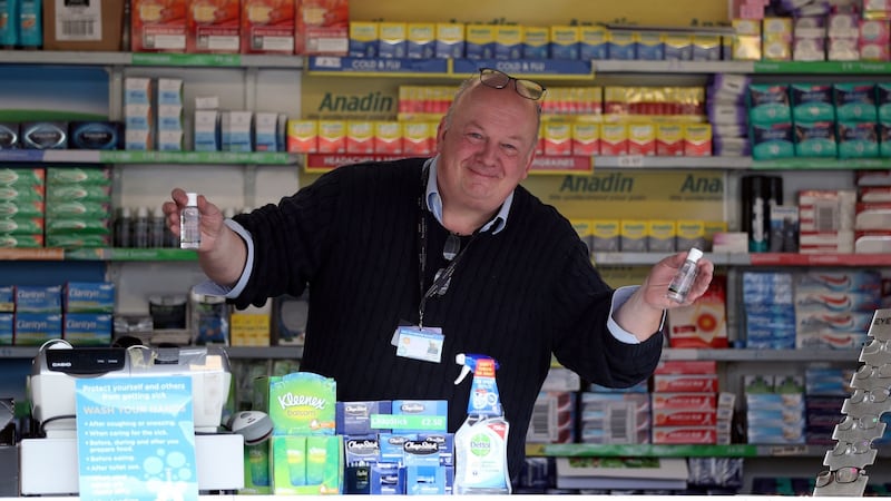 A member of staff on board a mobile pharmacy holds up two bottles of hand sanitiser on day one of the Cheltenham Festival. Photograph: Simon Cooper/PA Wire
