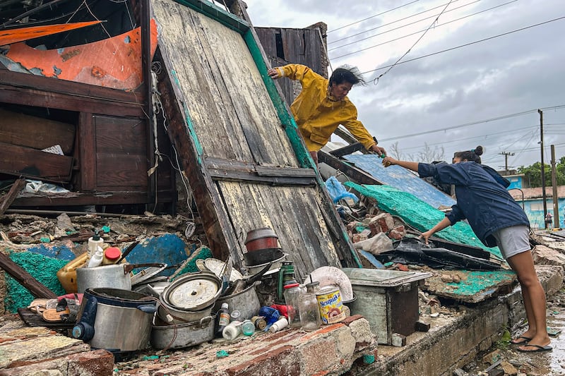 A family salvages belongings from the rubble of their home after it collapsed during Hurricane Melissa's passage through Santiago de Cuba, Cuba. Photograph: Yamil Lage/AFP via Getty Images