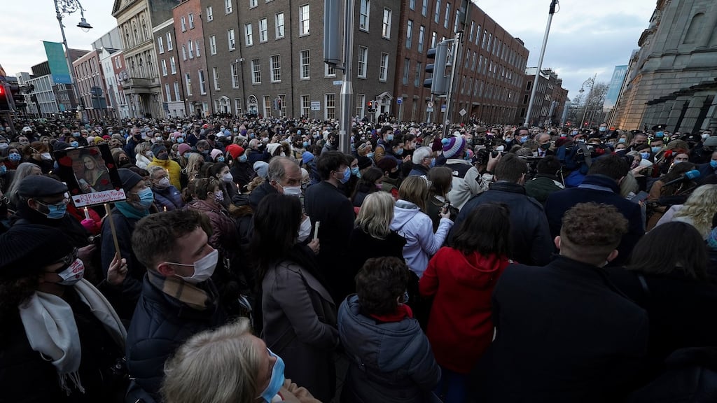 People gather for a vigil at Leinster House, Dublin, for the murdered Ashling Murphy. Thousands of people attended vigils and memorials for the school teacher and musician over the weekend. Photograph: PA