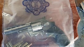 Cash, fake firearm and mobile devices seized in Garda raids