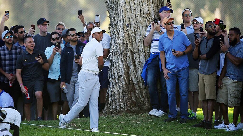 Tiger Woods watches his approach shot from the rough on the 11th fairway during the second round of the Genesis Open at Riviera Country Club. Photo: Reed Saxon/Ap Photo