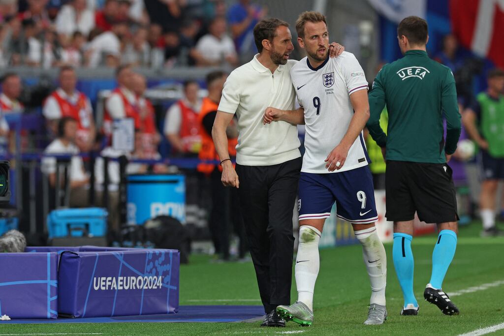 Gareth Southgate speaks with Harry Kane as he comes off during the UEFA Euro 2024 Group C football match between Denmark and England at the Frankfurt Arena. Photograph: Adrian Dennis/AFP via Getty Images