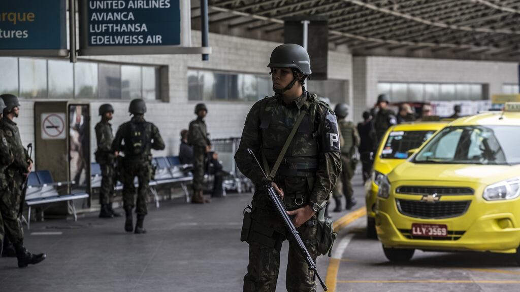 Military personnel outside the departure area of Galeao International Airport ahead of the 2016 Olympic Games in Rio de Janeiro, Brazil. Photographer: Dado Galdieri/Bloomberg
