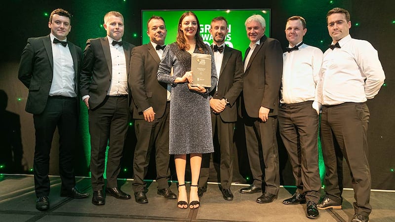 Dr Barry McDermott, Group Head of Sustainability, PM Group presents the Green Business of the Year award to the Mace Team.