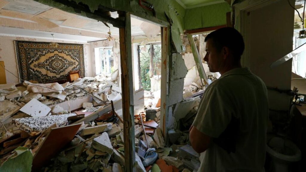 A local resident stands inside an apartment inside a block of flats damaged by a recent shelling in the eastern Ukrainian town of Kramatorsk. Photograph: Reuters