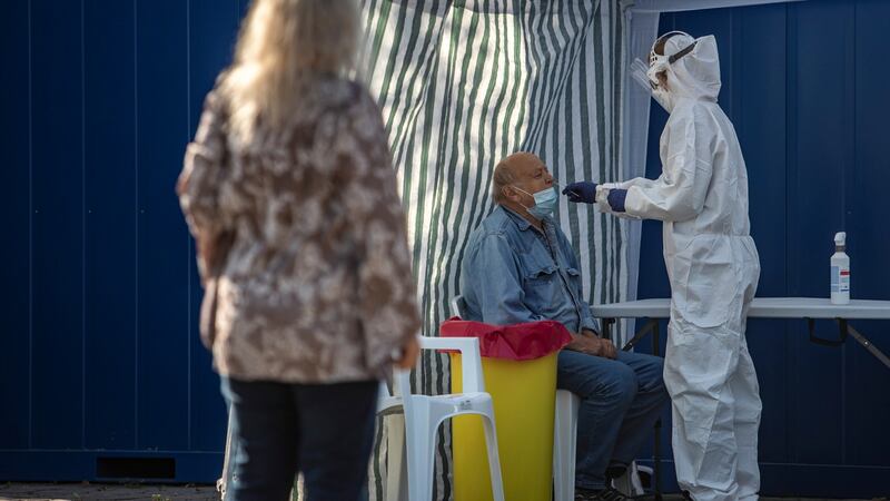 A medical worker takes a swab sample from a man at a coronavirus testing station in Prague, Czech Republic. Photograph: Martin Divisek/EPA