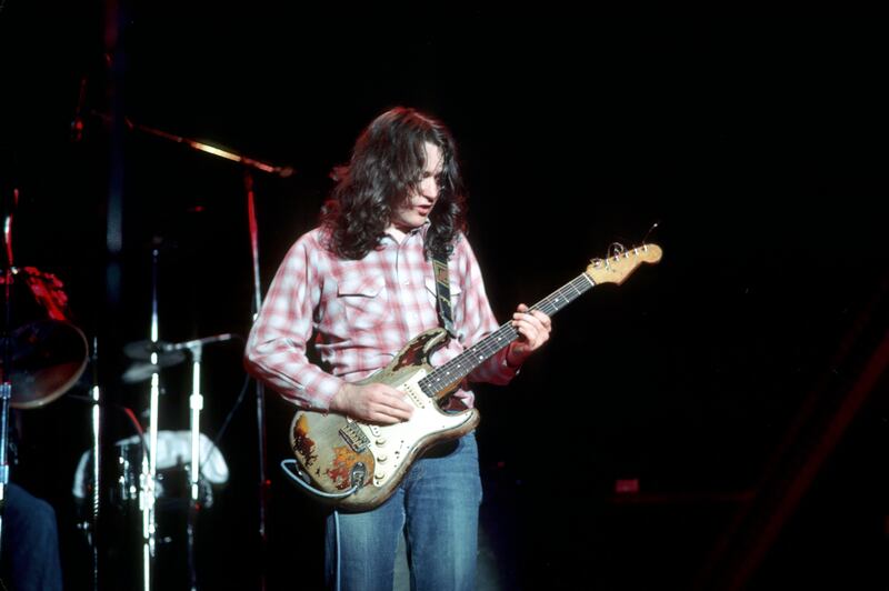 Rory Gallagher playing his signature sunburst Fender Stratocaster guitar. Photograph: Michael Ochs Archives/Getty Images