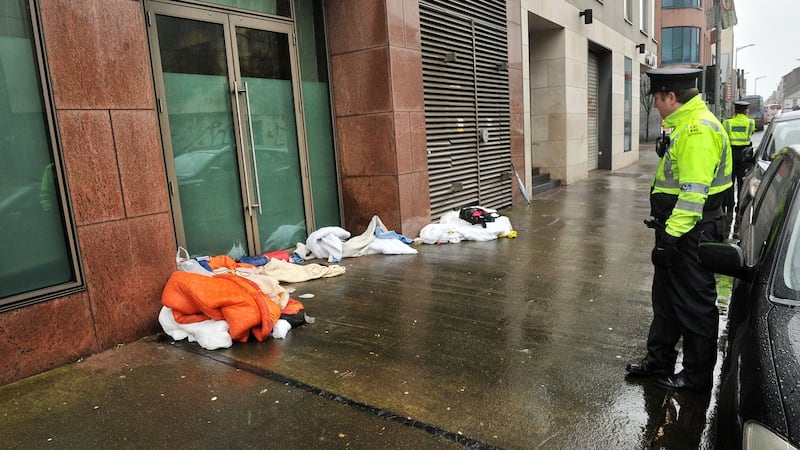 Gardaí on Lower Oliver Plunkett street near the Anderson’s Quay emergency shelter, where Kathleen O’Sullivan was found dead. Photograph: Daragh McSweeney/Provision