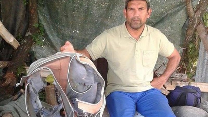 Johnny Begue, a member of a local shore cleaning association, poses  in Saint-Andre on the Indian Ocean island of La Reunion, with the remains of a suitcase. Photograph:  Linfo.re/Antenne Réunion/AFP/Getty Images