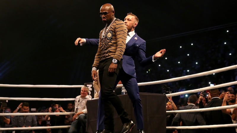 McGregor dances behind Mayweather during the press conference at the SSE Arena, Wembley. Photo: Scott Heavey/PA Wire