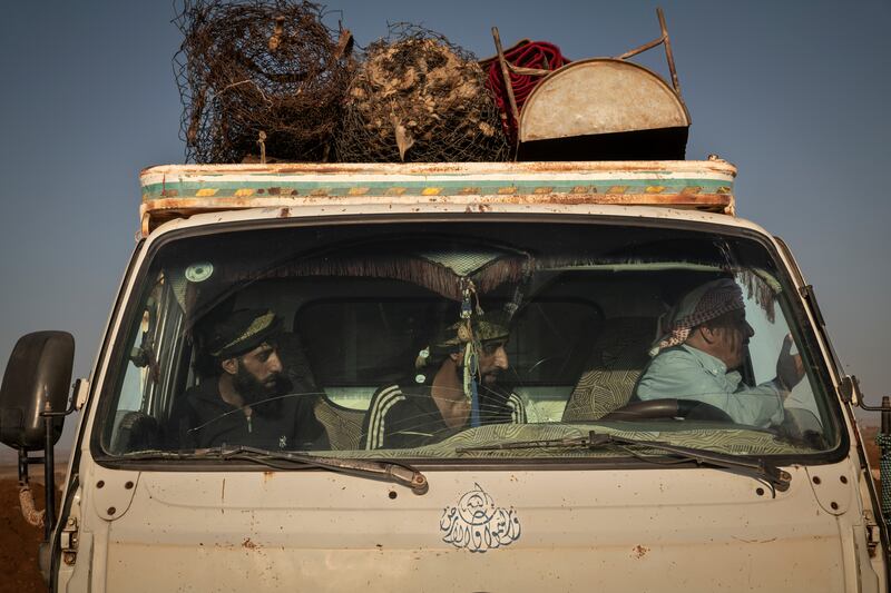 Bedouins answer questions from government troops at a checkpoint while evacuating their farming equipment and belongings from Sweida at a checkpoint near Busra, Syria last month. Photograph: Nicole Tung/The New York Times