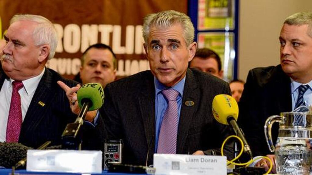 Seamus Murphy of the Psychiatric Nurses Association, Liam Doran (centre) of the Irish Nurses and Midwives Organisation and John Clinton of the Prison Officers Association speaking at a meeting at the INMO headquarters in Dublin yesterday. photograph: cyril byrne