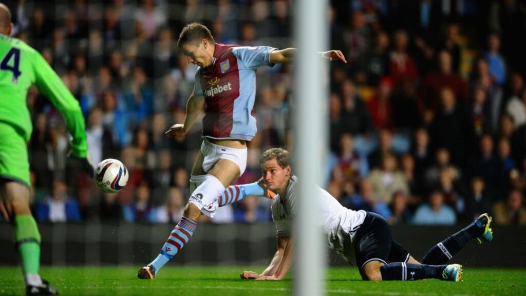 Jan Vertonghen of Tottenham Hotspur hangs on to the shorts of Nicklas Helenius of Aston Villa during their Capital One Cup third round match at Villa Park. Photograph: Photo by Laurence Griffiths/Getty Images