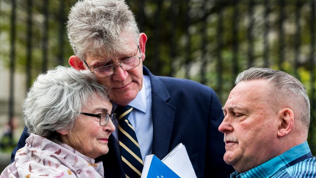 Kate McCausland embraced by Survivors North West Jon McCourt and John Heaney after speaking of her mother Una Irvine outside Belfast’s High Court after a failed bid to force the Northern Ireland Secretary of State Karen Bradley to compensate victims of historical sexual abuse. Photograph: Liam McBurney/PA Wire