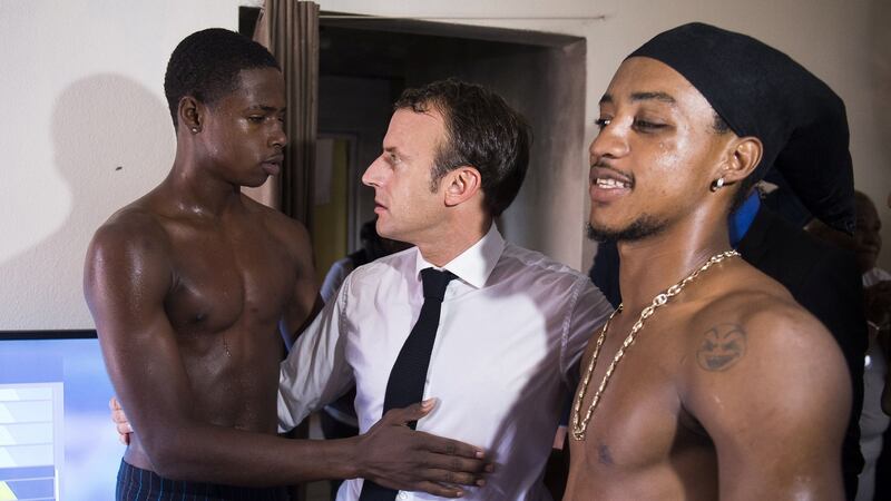 French president Emmanuel Macron speaks with two youths in the Quartier Orleans during a visit to the French Caribbean island of Saint Martin on Saturday. Photograph: Eliot Blondet/Reuters