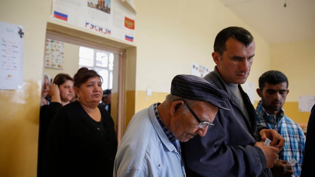 Kosovo Serbs queue to casts their votes during Serbian parliamentary election in the town of Gracanica, Kosovo. Photograph: Valdrin Xhemaj/EPA