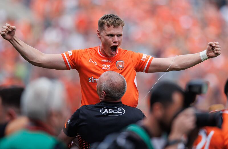 Armagh's Oisin O'Neill is lifted up by selector Kieran Donaghy after the All-Ireland victory. O'Neill made a big impact from the bench. Photograph: Tom Maher/Inpho