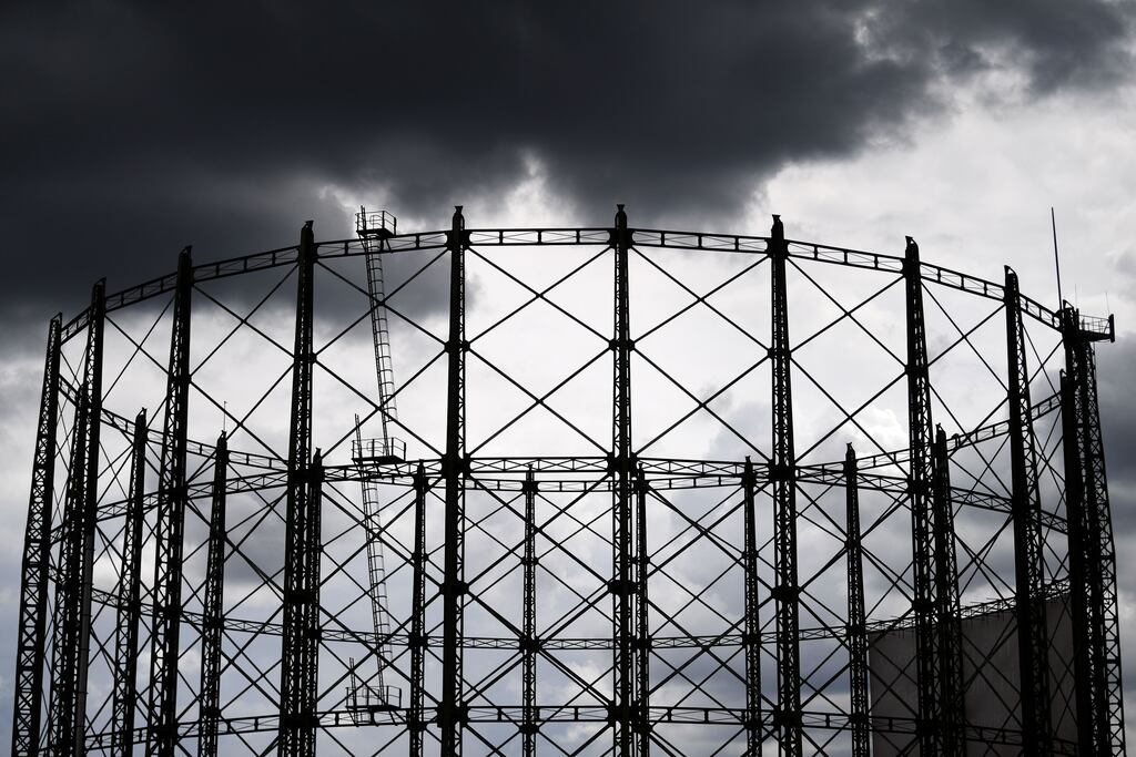 Clouds gather over a decommissioned gas holder in London, Britain, 27 July 2022. Gas holders or gasometers were used in the 20th Century to store natural gas for usages in towns. Oil and gas prices have soared in the UK in part due to the war in Ukraine. UK Households are facing a cost of living crisis due to the rising cost of energy and food.