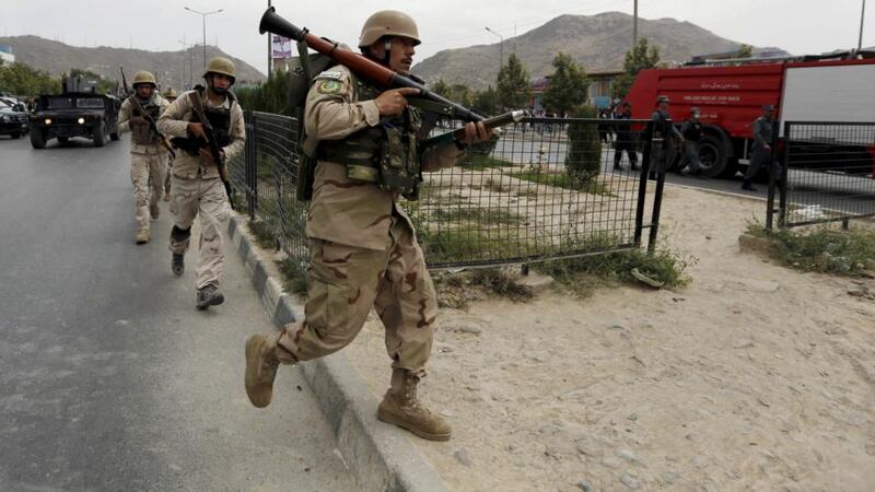 Afghan security forces arrive at the site of an attack near the Afghan parliament in Kabul, Afghanistan June 22, 2015. A Taliban suicide bomber and gunmen attacked the Afghan parliament on Monday, shattering windows, wounding at least 19 people and sending a plume of black smoke across Kabul, as a second district in two days fell to the Islamist group in the north. REUTERS/Mohammad Ismail