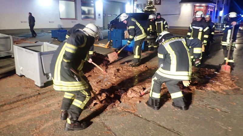 Fireman clear spilt chocolate from the road. Photograph: Reuters