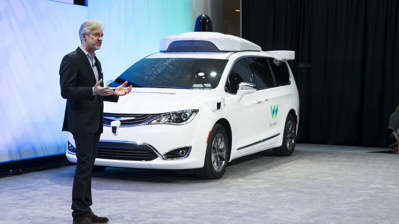 John Krafcik, chief executive of Waymo, unveiling a self-driving people carrier.