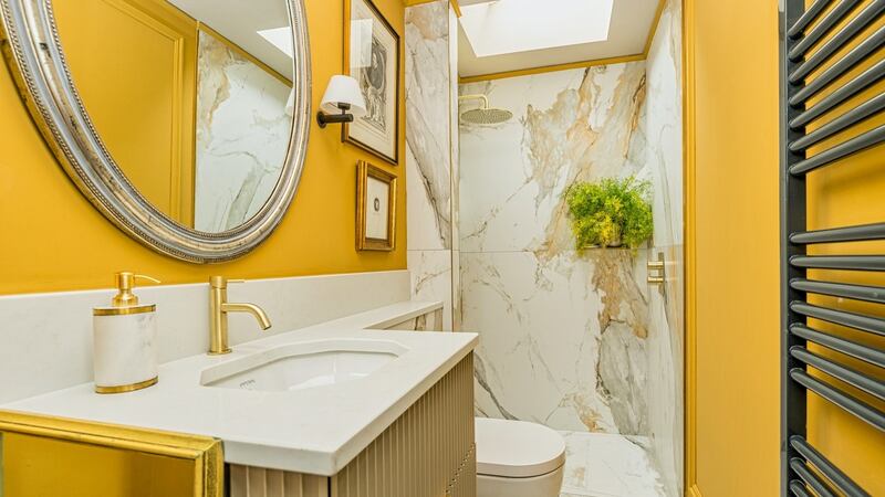 The internal en suite here, hidden behind an Arte-clad door, is mustard and gold and white marble