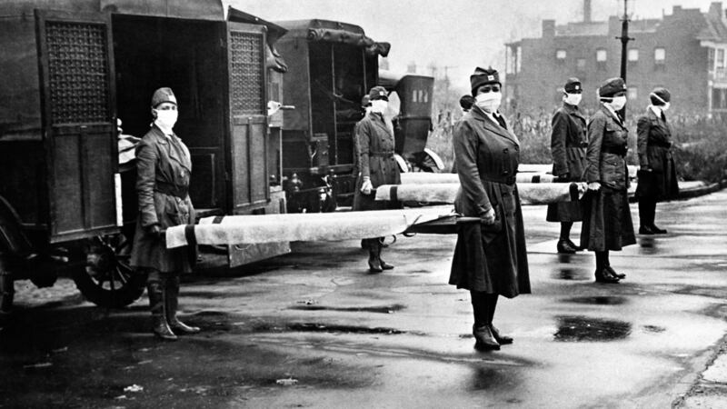 The St Louis Red Cross Motor Corps on duty in the US with mask-wearing women holding stretchers at the backs of ambulances during the Spanish Flue epidemic of 1918. Photo: Underwood Archives/Getty Images