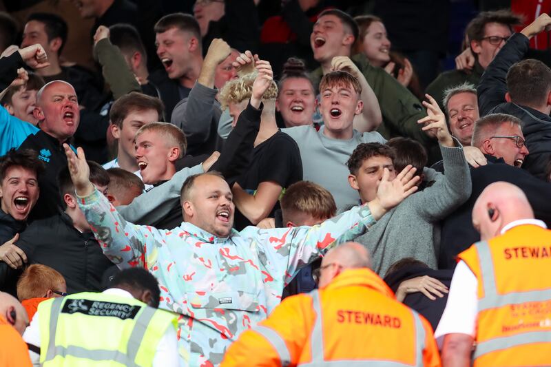 Lincoln City fans celebrate their side's first goal of the game, scored by Ben House (not pictured) during the Sky Bet League One match at Portman Road, Ipswich, last weekend.