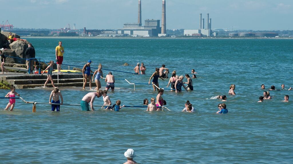 Swimmers enjoy the sunshine at Seapoint in Dublin. The August bank holiday will start off dry and sunny but will turn wet on Monday with the possibility of torrential rain and spot flooding. Photograph: Dave Meehan/The Irish Times.