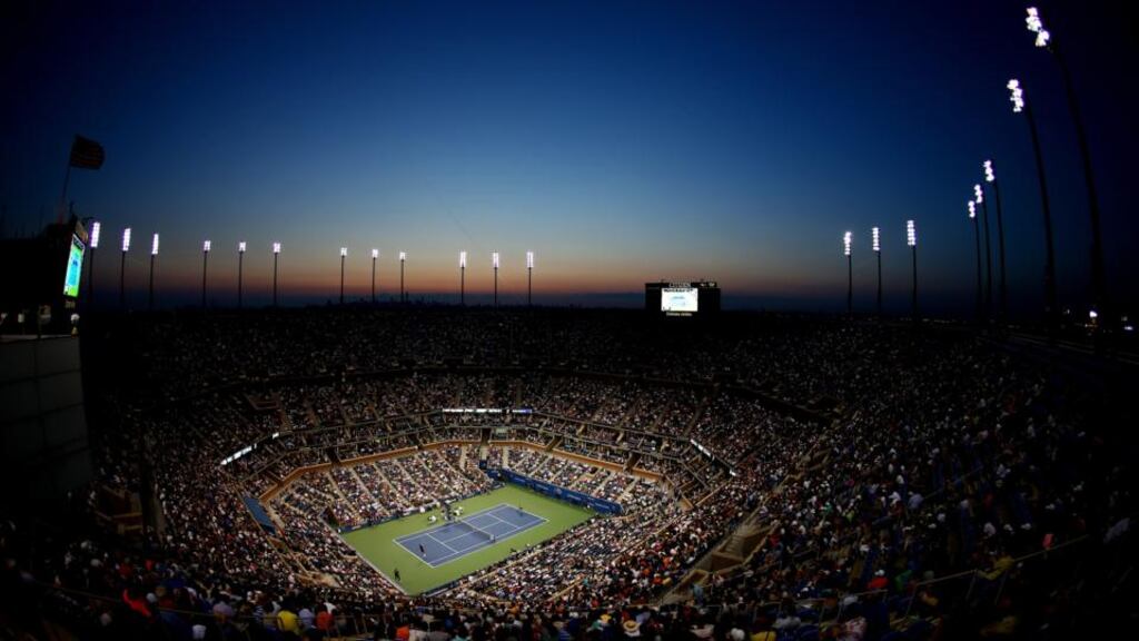 The sunsets as Roger Federer of Switzerland plays against Marinko Matosevic of Australia during their men’s singles first round match on Day Two of the 2014 US Open in New York. Photograph: Streeter Lecka/Getty Images