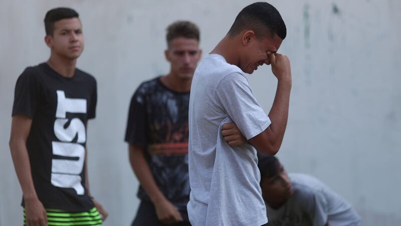 People wait for information in front of the training centre of Rio soccer club Flamengo. Photograph: Ricardo Morae/Reuters