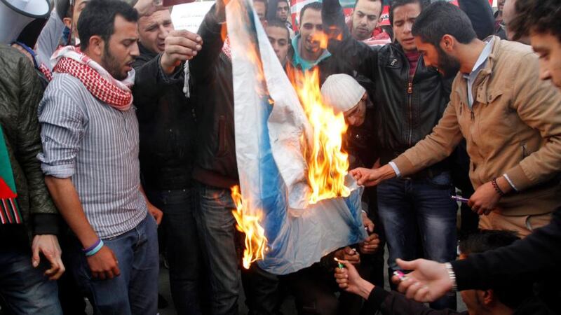 Jordanian protesters burn an Israeli flag during a protest in front of Jordanian Parliament in Amman. Photograph:  Jamal  Nasrallah/EPA