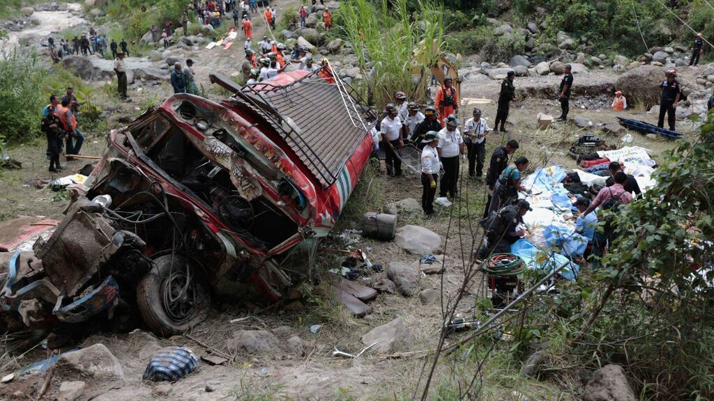 Forensic technicians work at a bus crash site in San Martin Jilotepeque, Chimaltenango region. At least 38 people were killed and dozens injured on Monday when the bus went off a cliff on a hairpin bend in rural Guatemala, tumbling some 200 meters into a river at the bottom of a ravine, officials said. Photograph: Jorge Dan Lopez/Reuters
