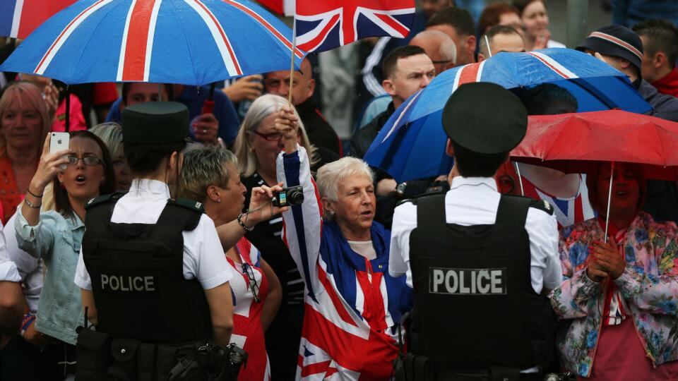Loyalist supporters cheer on an Orange Order parade on Crumlin Road. Photograph: Brian Lawless/PA Wire