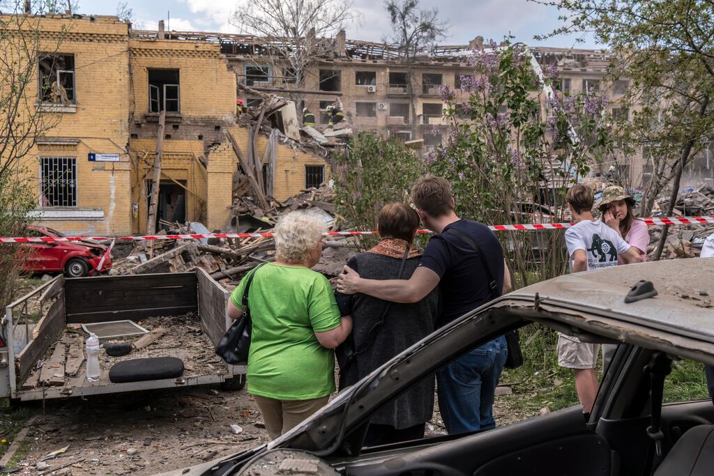 A group of people watch as rescue workers search for people presumed to have been buried beneath the rubble of an apartment building that was destroyed by a Russian missile strike in Kyiv, Ukraine, last month. Photograph: Brendan Hoffman/The New York Times