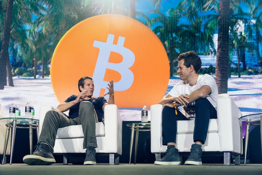 Tyler, left, and Cameron Winklevoss speak at the Bitcoin Festival in Miami, June 4, 2021. Crypto companies are laying off staff, freezing withdrawals and trying to stem losses, raising questions about the health of the ecosystem. Photograph: Alfonso Duran/The New York Times