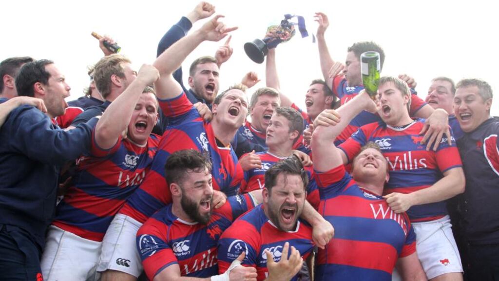 Clontarf’s players and backroom staff celebrate after they claimed their first Ulster Bank League Division 1A title with a victory over Ballynahinch at Castle Avenue on Saturday. Photograph: Colm O’Neill/Inpho