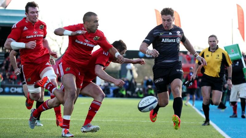 Munster’s Simon Zebo and Felix Jones are too late to prevent Chris Wyles of Saracens getting his kick through to Chris Ashton for the second try at Allianz Park. Photograph: Dan Sheridan/ Inpho