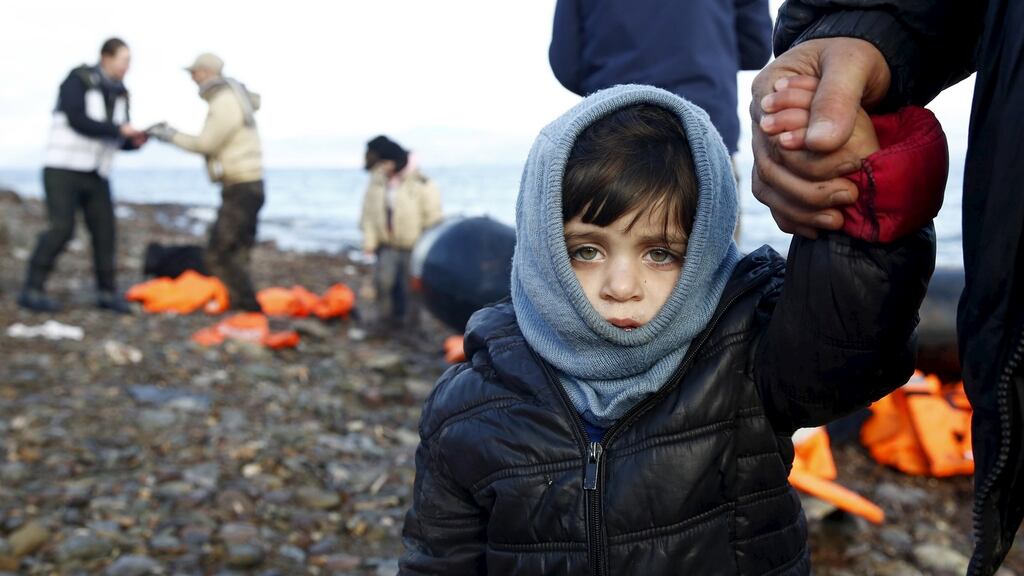 A Syrian refugee child looks on, moments after arriving on a raft with other Syrian refugees on a beach on the Greek island of Lesbos on Monday. More than 500,000 refugees and migrants entered Greece through its outlying islands last year. Photograph: Giorgos Moutafis/Reuters