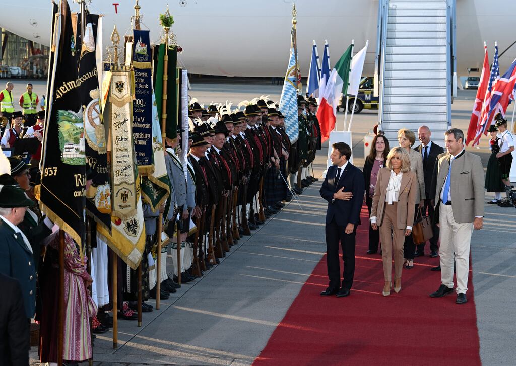France's president Emmanuel Macron and his wife Brigitte Macron are greeted by Bavaria's state premier Markus Soeder and a Bavarian honour guard upon their arrival on the eve of the G7 summit. Photograph: Christof/Stache/AFP/Getty Images